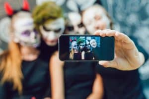 Friends dressed up for Halloween taking a selfie